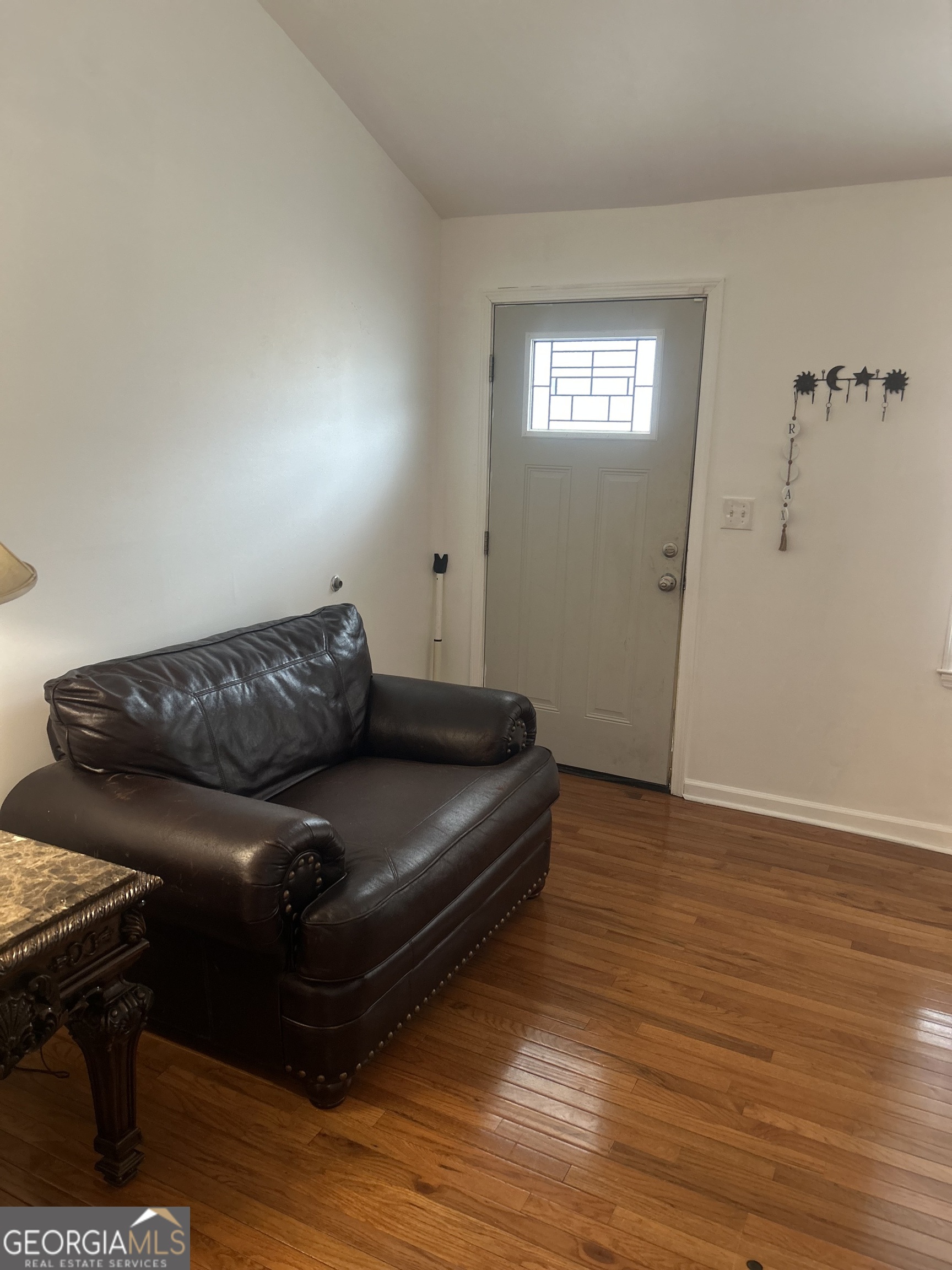 1406 Canterbury Road Griffin, GA 30223 - Photo 7 of 26 a living room with furniture and a wooden floor