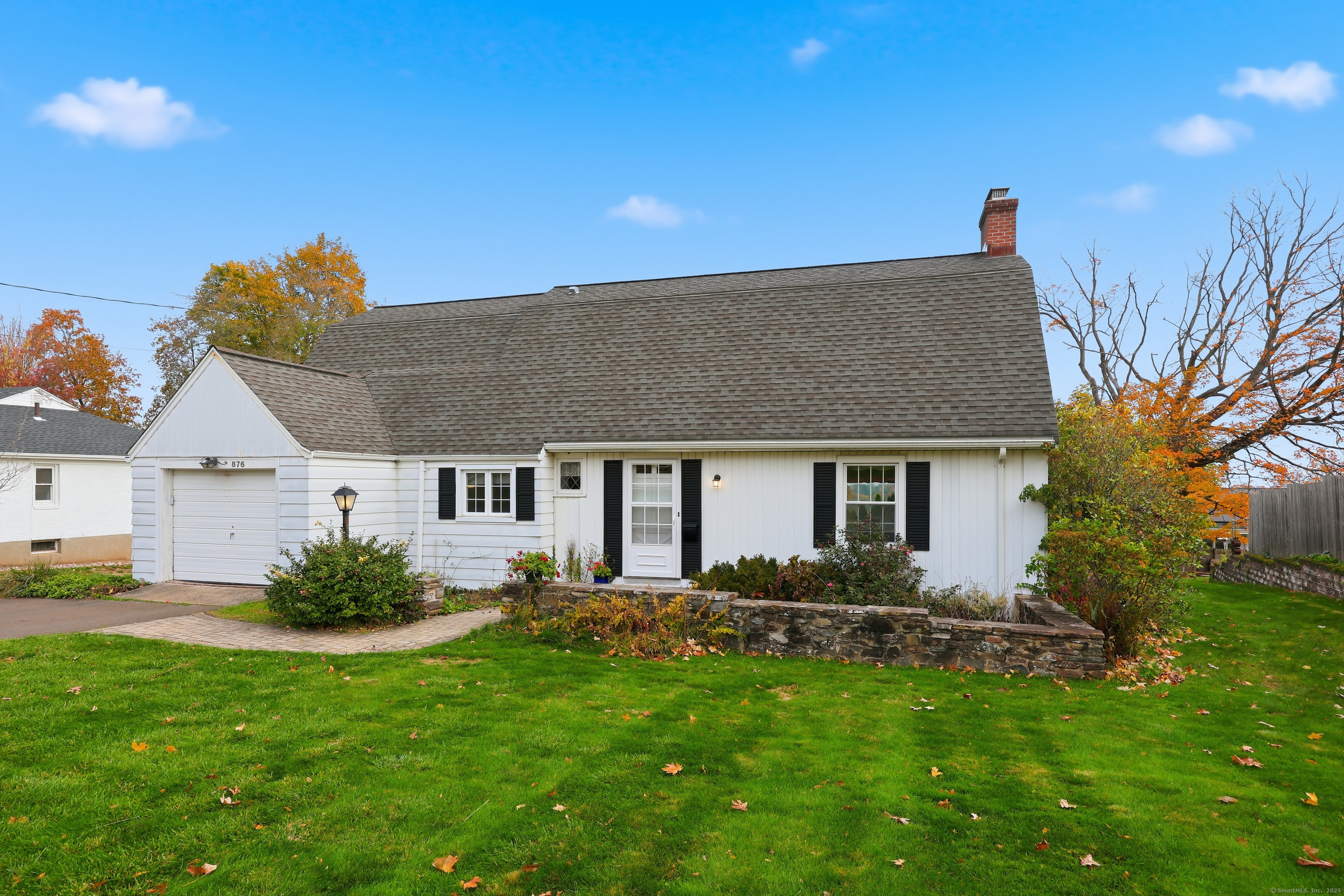 876 Ridge Road Wethersfield, CT 06109 - Photo 1 of 1 a front view of house with yard and outdoor seating