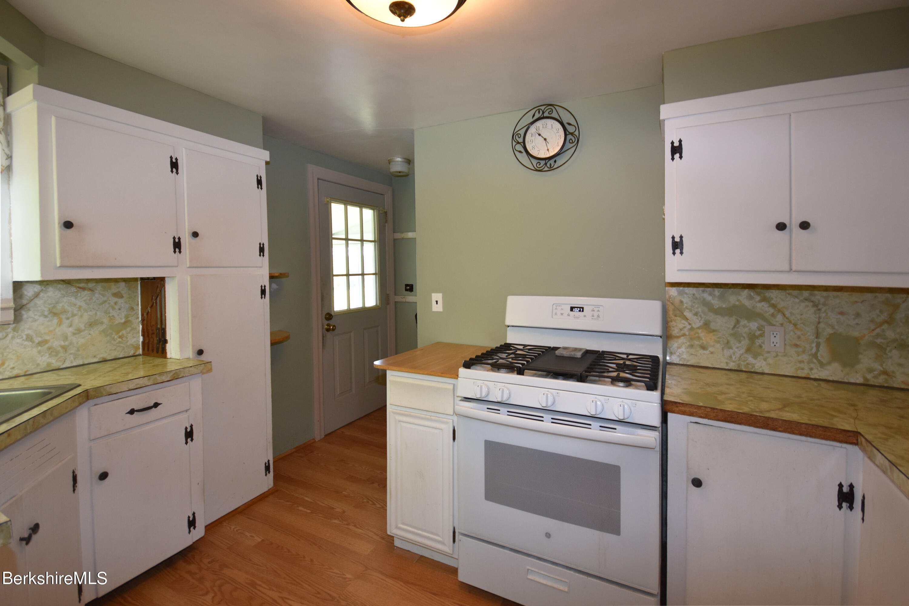 1649 State Road Richmond, MA 01254 - Photo 14 of 43 a kitchen with cabinets appliances and a wooden floor