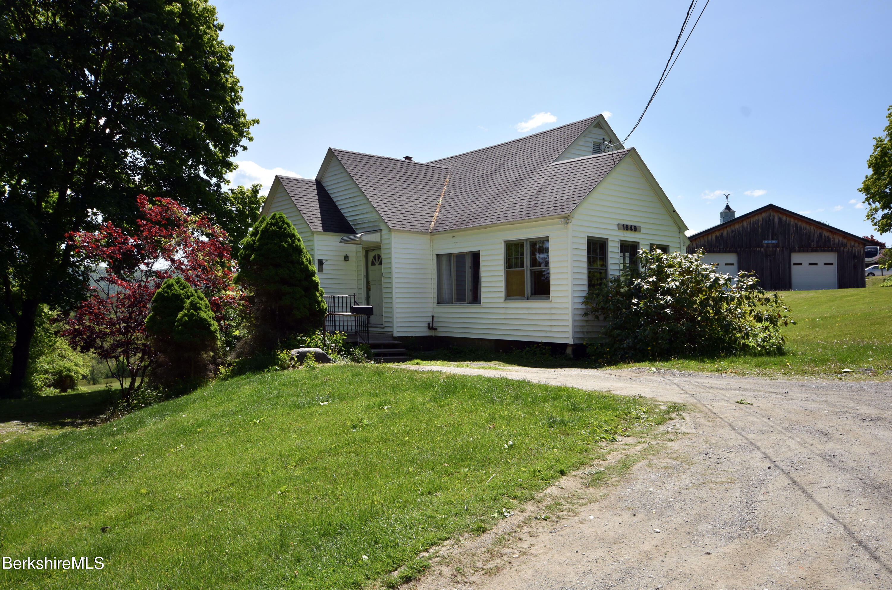1649 State Road Richmond, MA 01254 - Photo 4 of 43 a front view of a house with garden