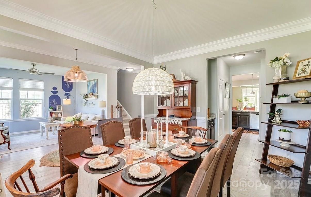 411 Stonefield Circle Moncks Corner, SC 29461 - Photo 19 of 42 a dining room with furniture a rug and wooden floor
