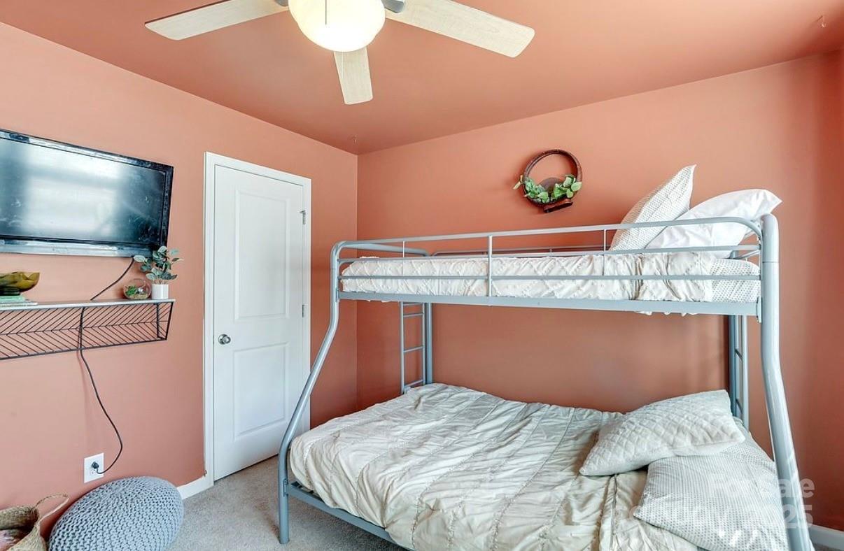 411 Stonefield Circle Moncks Corner, SC 29461 - Photo 28 of 42 a bedroom with a bed and a flat screen tv