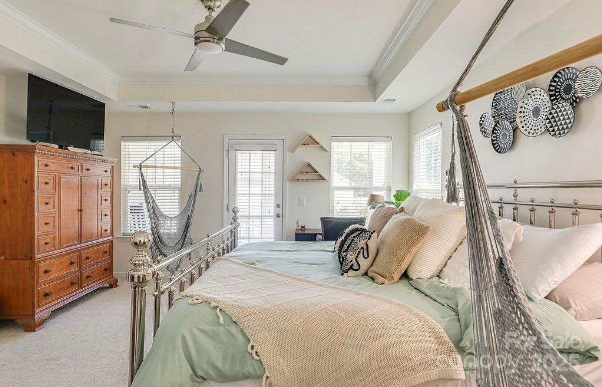 411 Stonefield Circle Moncks Corner, SC 29461 - Photo 38 of 42 a bedroom with a bed a flat screen tv and a large window