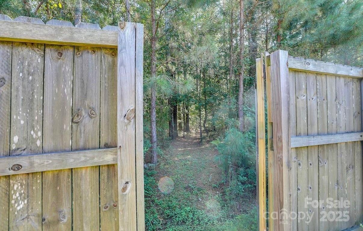 411 Stonefield Circle Moncks Corner, SC 29461 - Photo 7 of 42 a view of a small yard with wooden fence