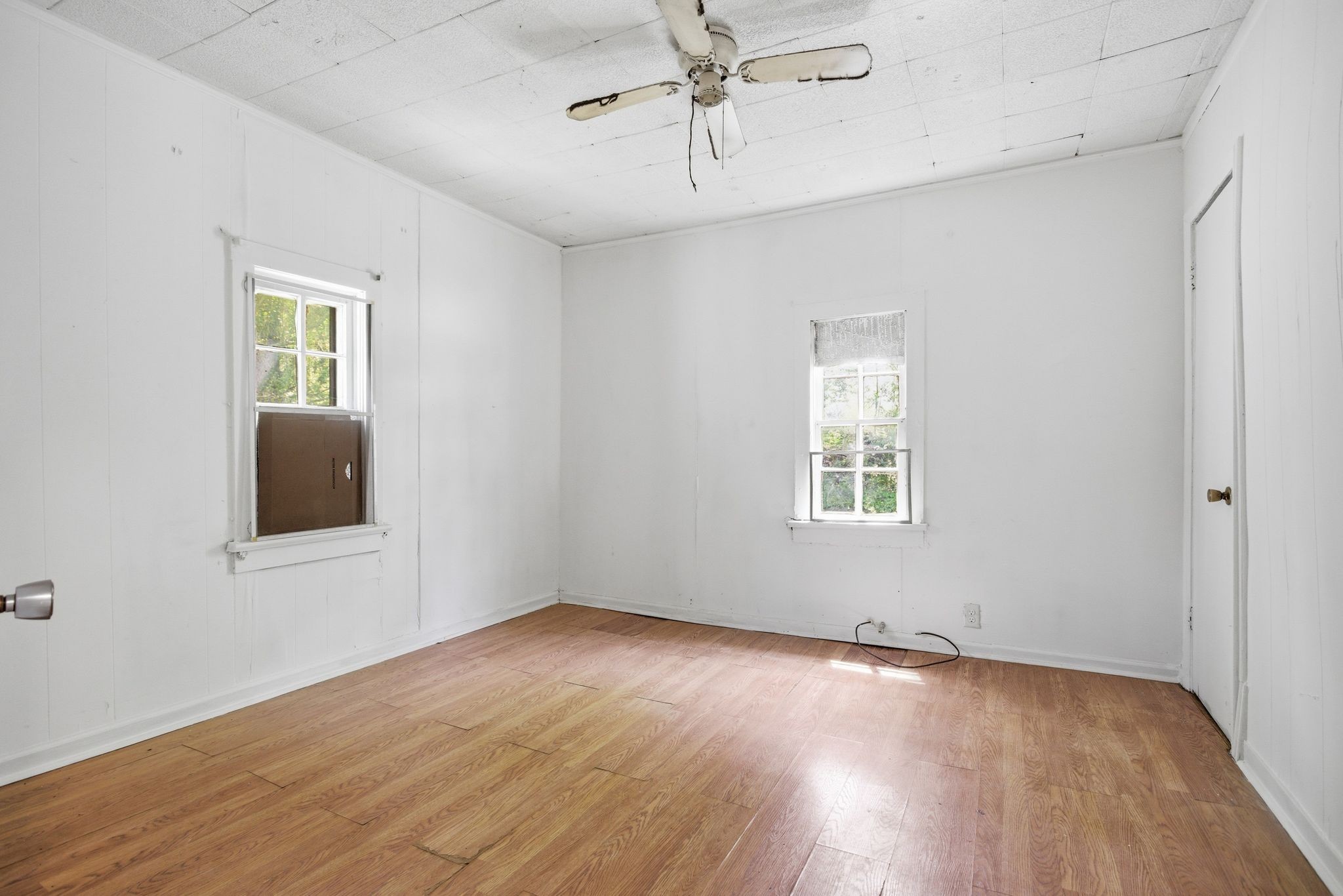 433 Jones Street Pulaski, TN 38478 - Photo 15 of 25 an empty room with wooden floor chandelier fan and windows