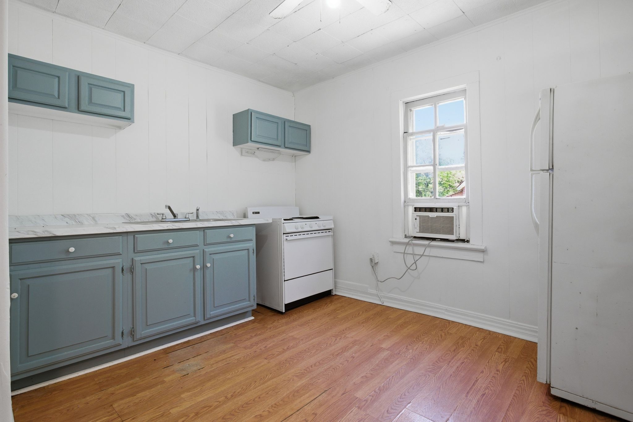 433 Jones Street Pulaski, TN 38478 - Photo 19 of 25 a kitchen with a sink cabinets and wooden floor