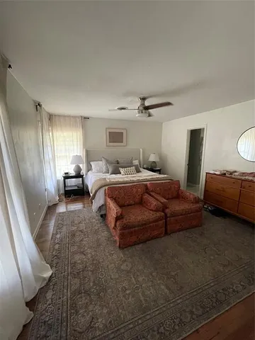 a bedroom with a bed couch and window