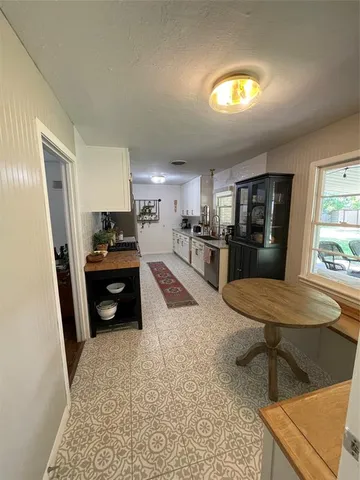 a kitchen with stainless steel appliances kitchen island granite countertop a refrigerator and a stove top oven
