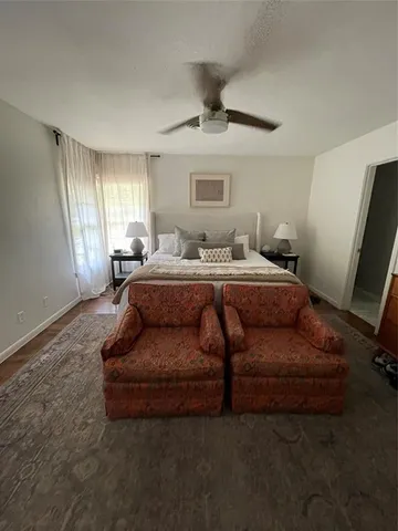 a bedroom with a bed couch and window