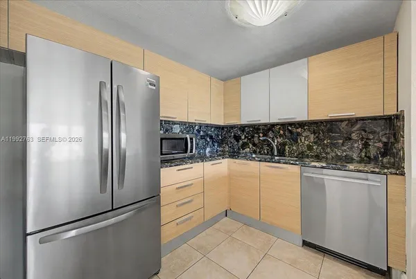 a view of kitchen with sink and cabinets