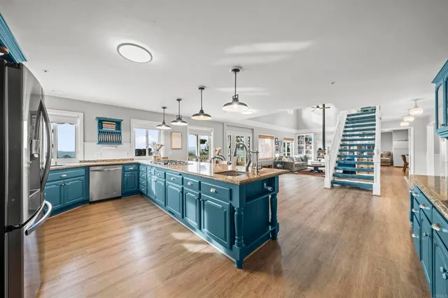 a large white room with a large window and white appliances