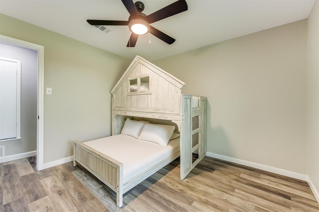738 Campground Road Sherman, TX 75090 - Photo 28 of 40 a bedroom with a bed and a ceiling fan