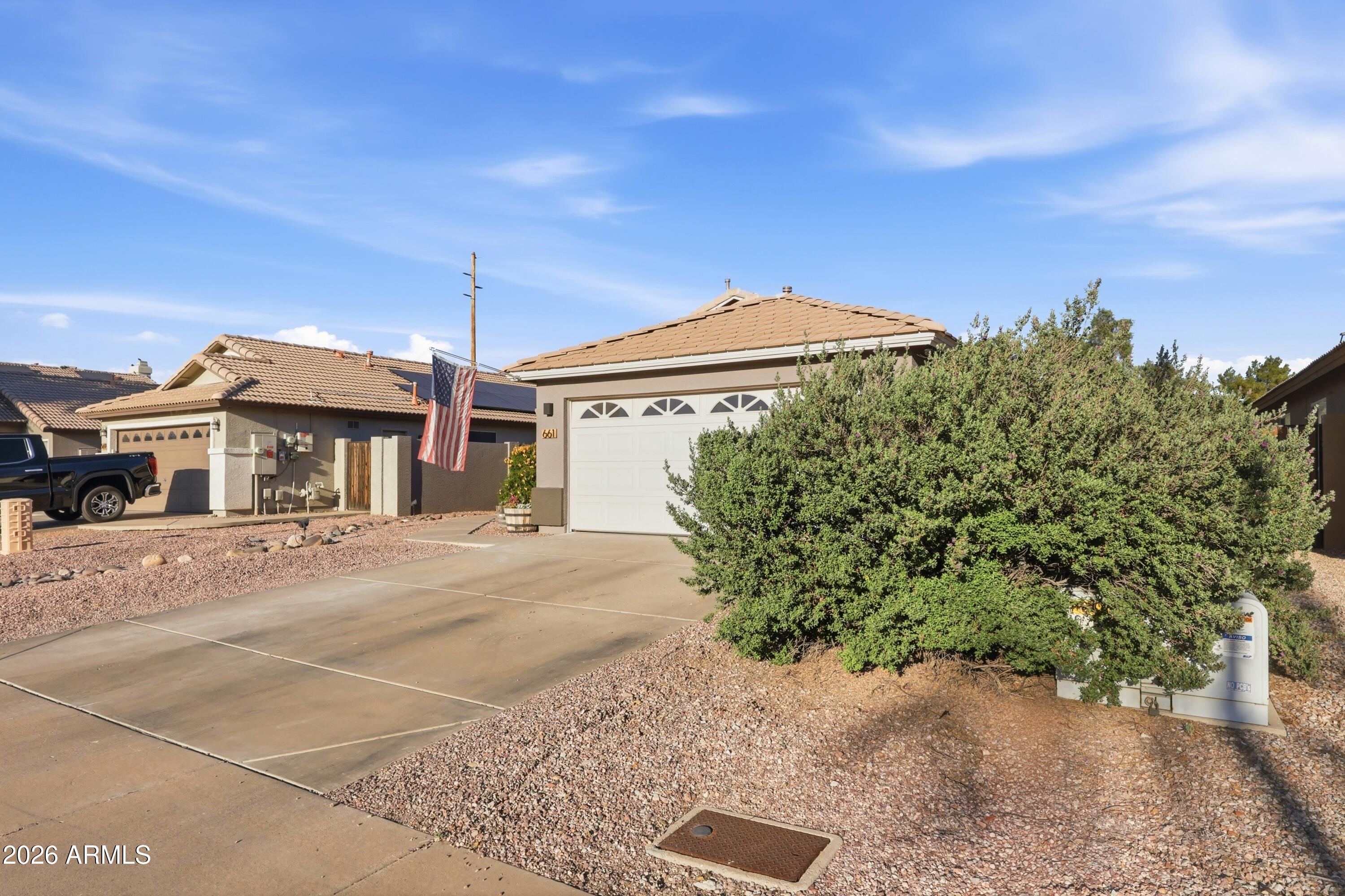 661 North Joshua Tree Lane Gilbert, AZ 85234 - Photo 3 of 47 a front view of a house with a yard and garage