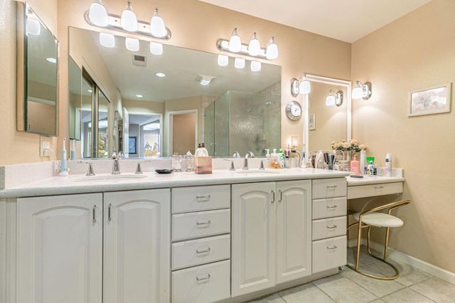 a bathroom with a sink vanity and mirror