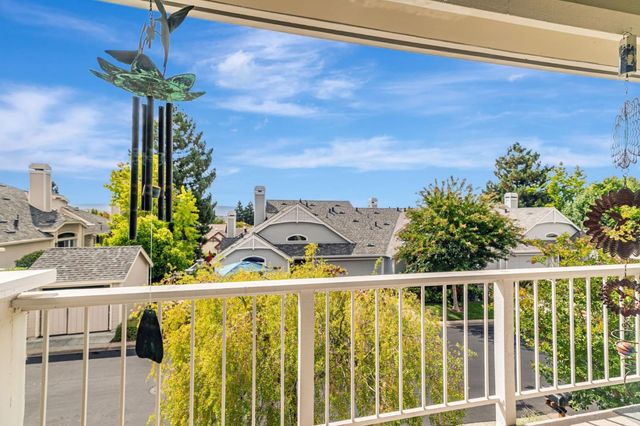 a view of a balcony with potted plants