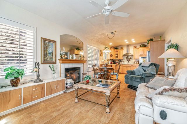 a living room with furniture a chandelier and a fireplace