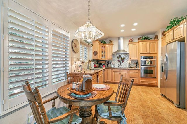 a dining room with a table or chairs and a dining table with kitchen view