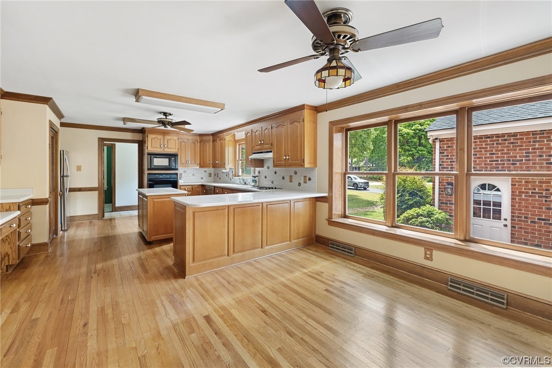 11100 Golden Leaf Road Chester, VA 23831 - Photo 13 of 39 a kitchen with stainless steel appliances granite countertop a stove a sink dishwasher and a refrigerator with wooden floor