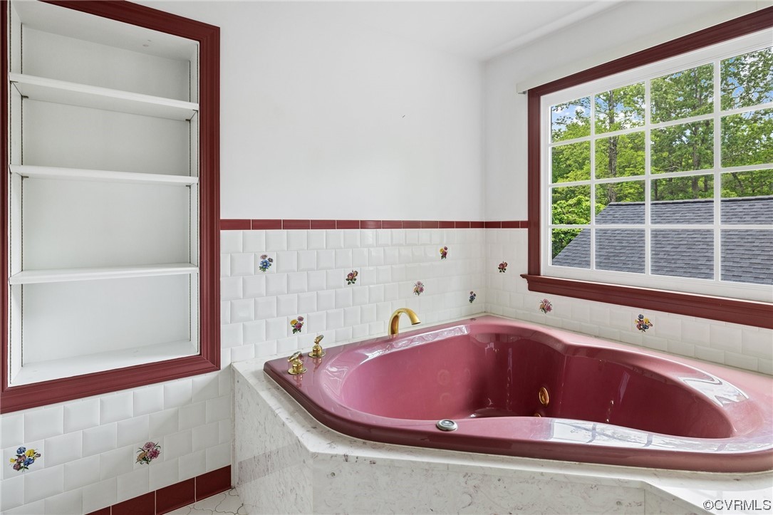11100 Golden Leaf Road Chester, VA 23831 - Photo 22 of 39 a bath tub sitting next to a window