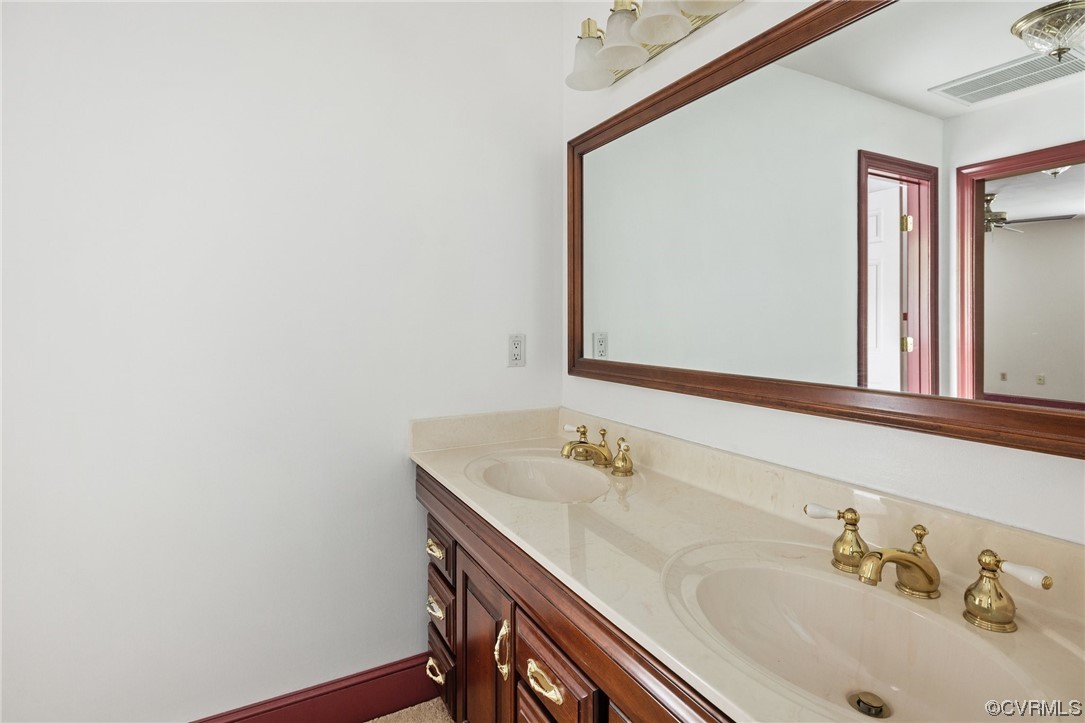 11100 Golden Leaf Road Chester, VA 23831 - Photo 23 of 39 a bathroom with a sink and a mirror