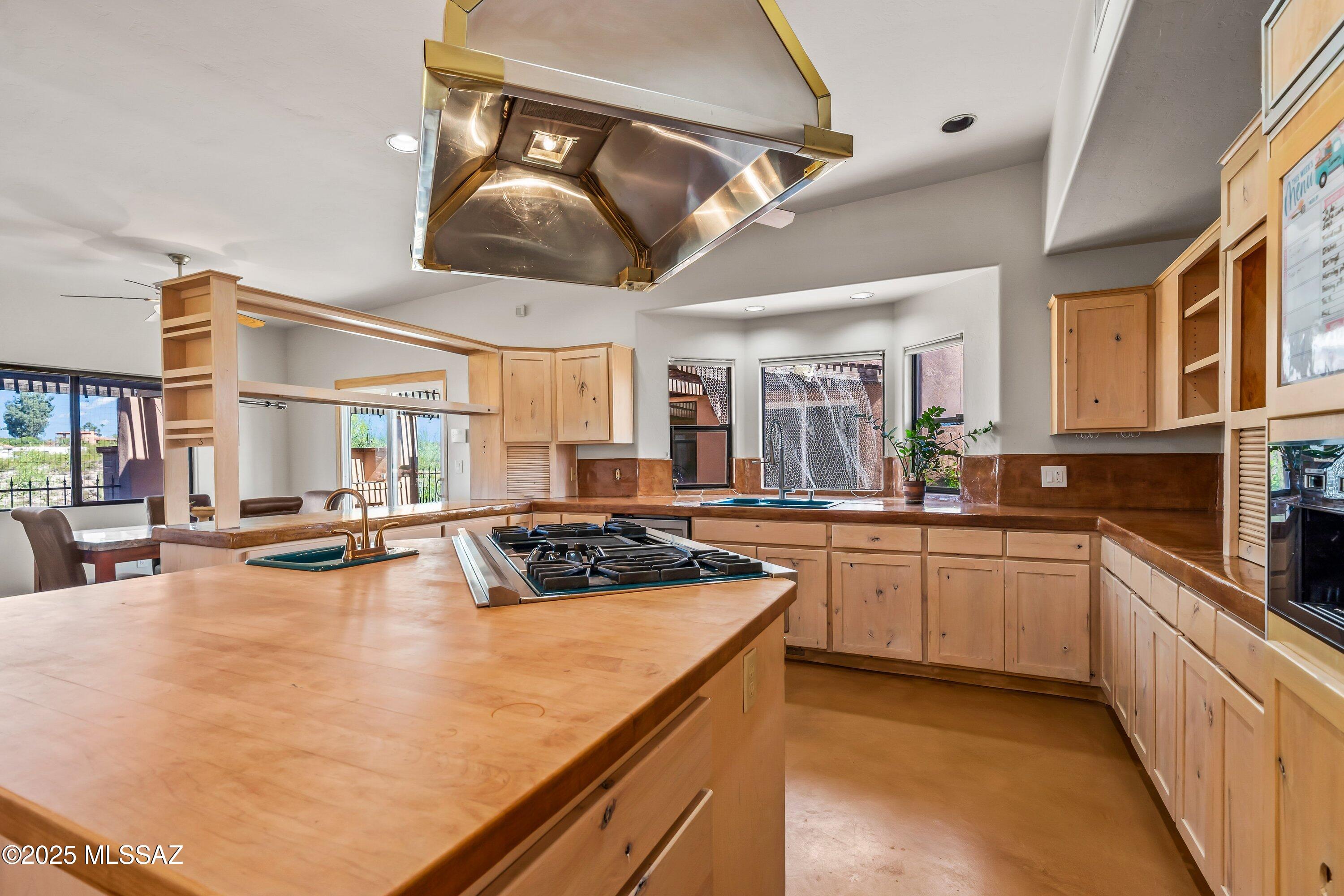 30 West Stone Loop Tucson, AZ 85704 - Photo 16 of 26 a kitchen with stainless steel appliances granite countertop a sink a stove and cabinets
