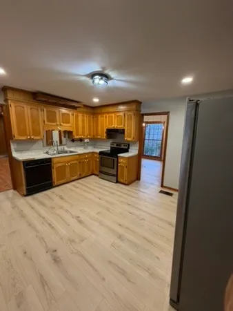 a view of kitchen with granite countertop lots of counter top space