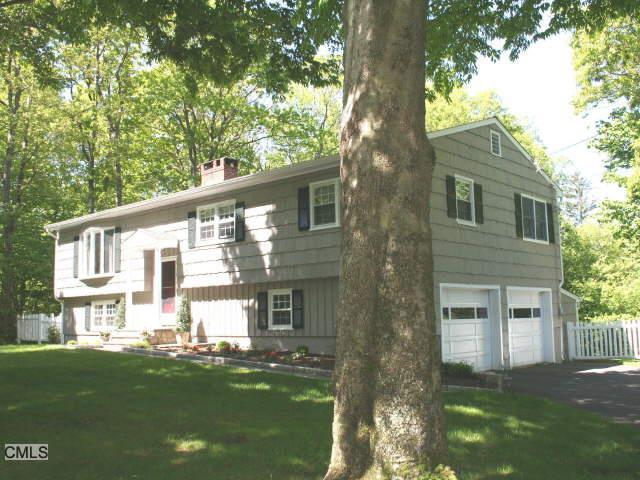 75 Acre Lane Ridgefield, CT 06877 - Photo 1 of 1 a front view of a house with a garden