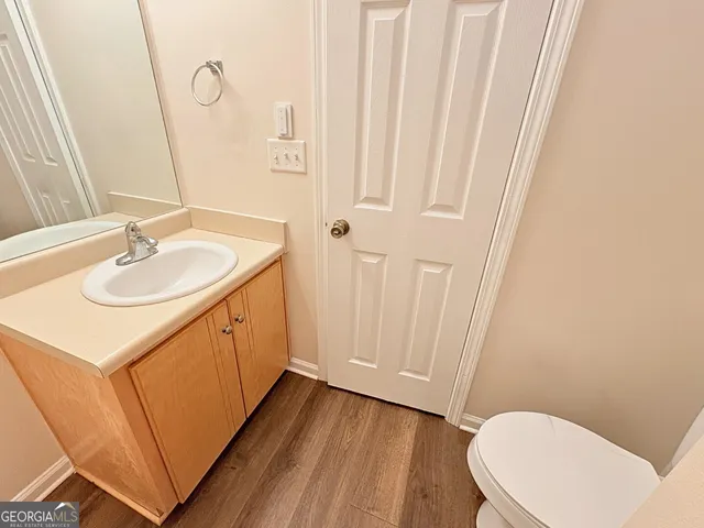 a bathroom with a sink a toilet and mirror