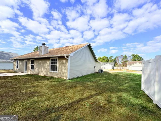 a big house with a big yard and large trees