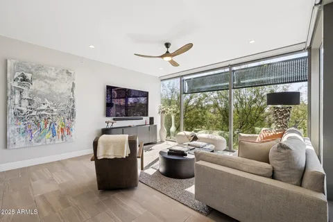 a view of a chairs and table in the balcony