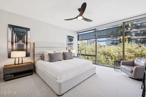 a bedroom with furniture and a flat screen tv