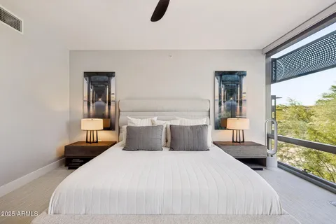 a bedroom with a bed couch and a flat screen tv