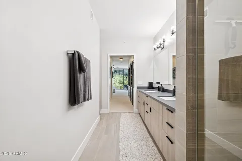 a bathroom with a granite countertop sink a toilet and a mirror