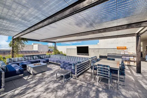 a outdoor space with lots of tables a chandelier and pool table