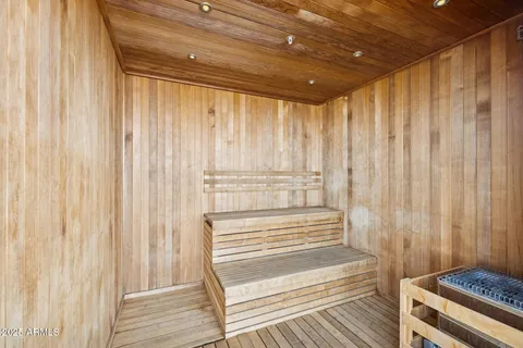 a living room with furniture a table and kitchen view