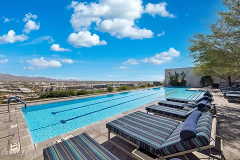 a patio with table and chairs and potted plants