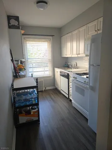 a kitchen with stainless steel appliances a stove a refrigerator and cabinets