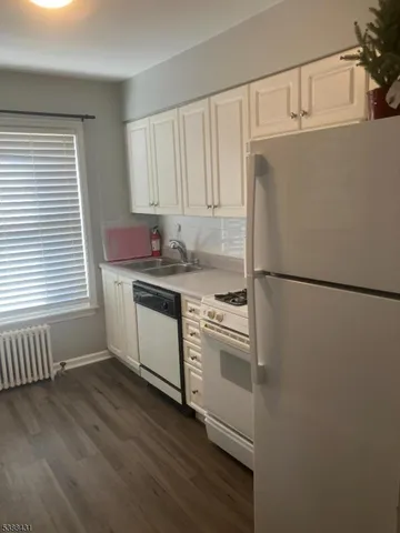 a white stove top oven sitting inside of a kitchen