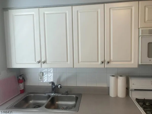 a kitchen with a sink and a refrigerator