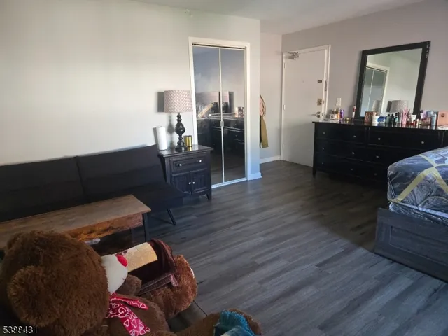 a bedroom with furniture and wooden floor