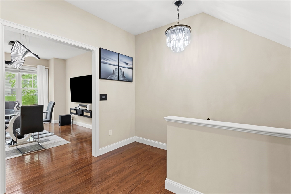 5D Manor Drive, Unit B Hooksett, NH 03106 - Photo 11 of 42 a view of a livingroom with wooden floor and a flat screen tv