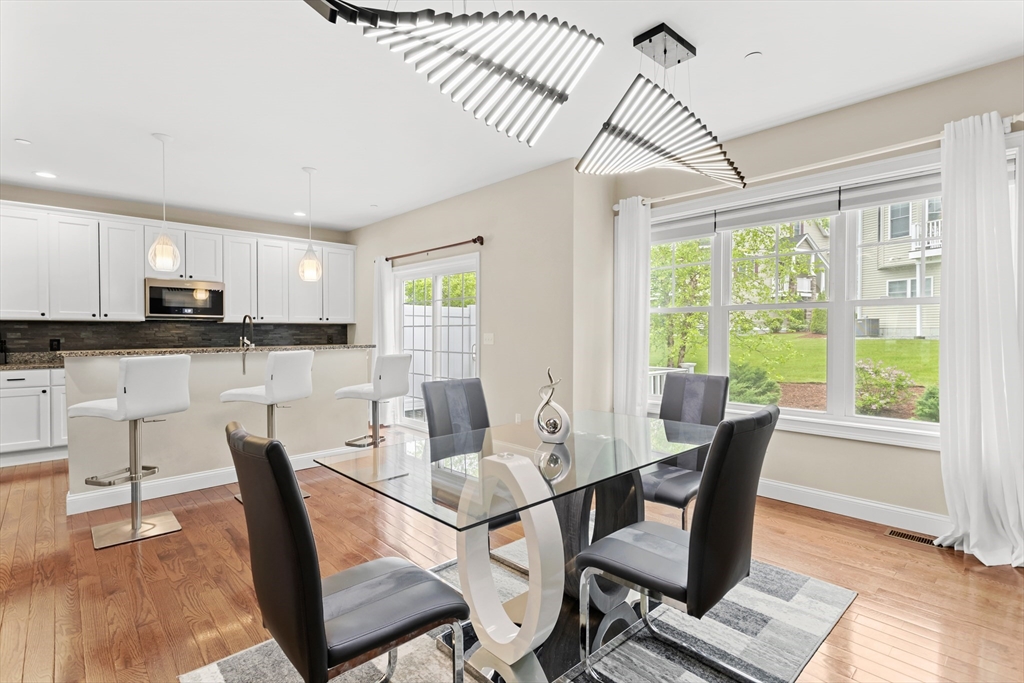 5D Manor Drive, Unit B Hooksett, NH 03106 - Photo 13 of 42 a view of a dining room with furniture window and wooden floor