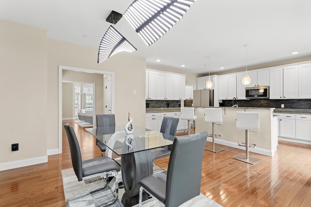 5D Manor Drive, Unit B Hooksett, NH 03106 - Photo 14 of 42 a view of kitchen with cabinets table and chairs