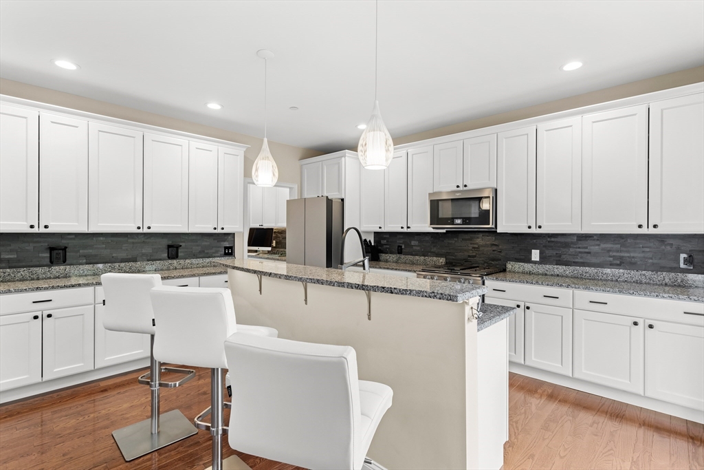 5D Manor Drive, Unit B Hooksett, NH 03106 - Photo 16 of 42 a kitchen with a sink white cabinets and white appliances