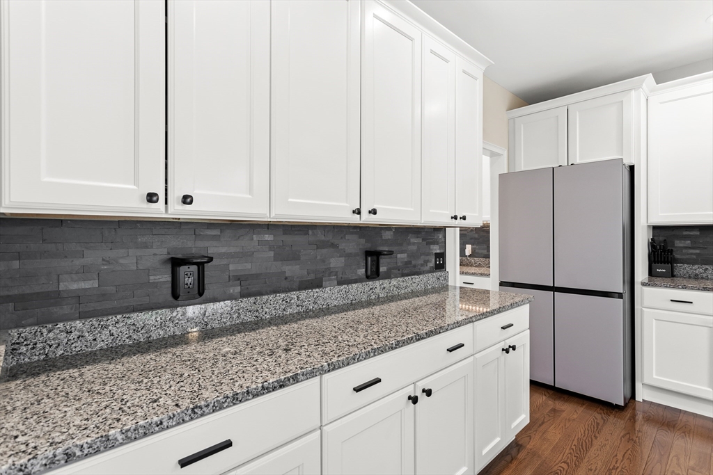 5D Manor Drive, Unit B Hooksett, NH 03106 - Photo 19 of 42 a kitchen with granite countertop white cabinets and refrigerator