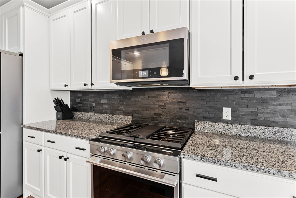 5D Manor Drive, Unit B Hooksett, NH 03106 - Photo 20 of 42 a kitchen with microwave cabinets and stove top oven