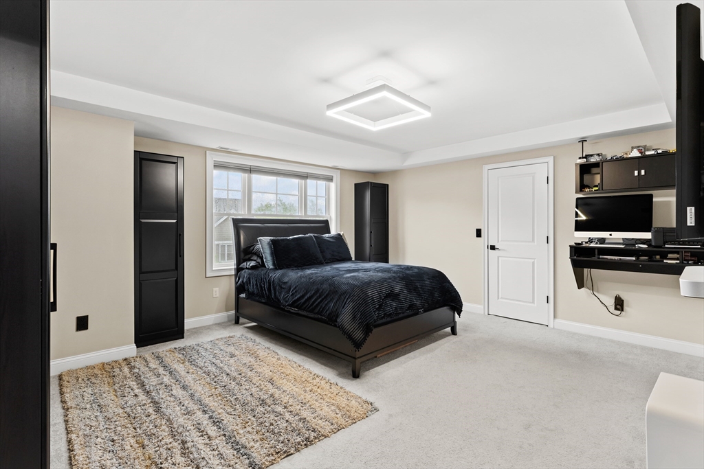 5D Manor Drive, Unit B Hooksett, NH 03106 - Photo 24 of 42 a bedroom with a bed and a television