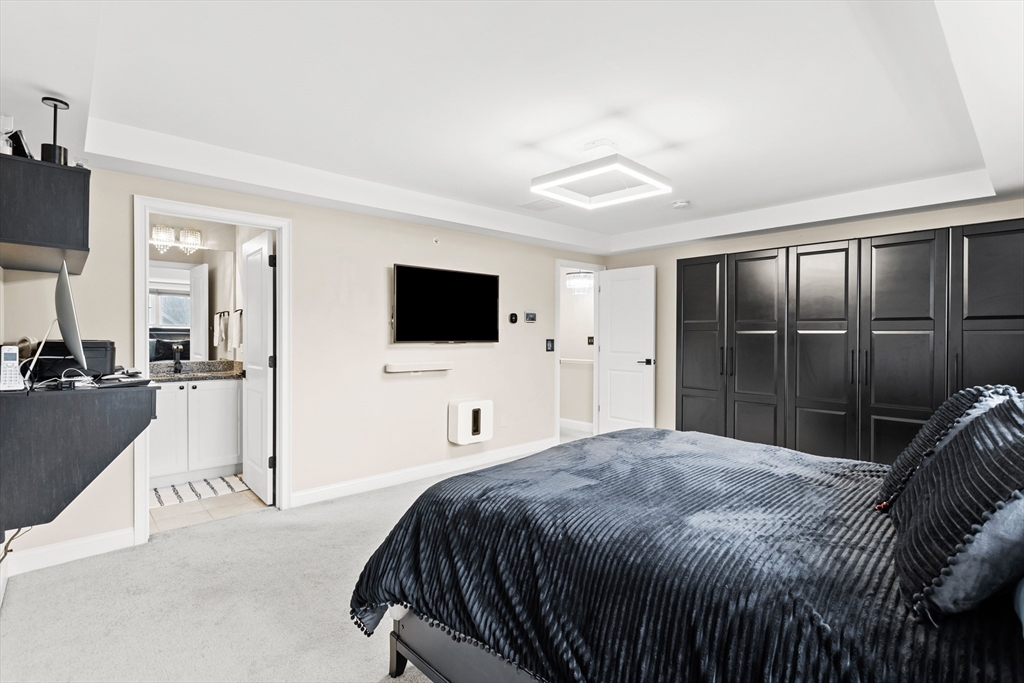 5D Manor Drive, Unit B Hooksett, NH 03106 - Photo 27 of 42 a bedroom with a bed and a flat screen tv