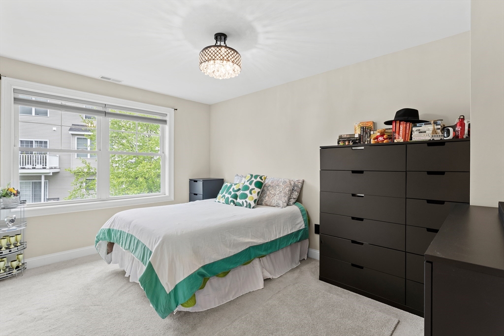 5D Manor Drive, Unit B Hooksett, NH 03106 - Photo 30 of 42 a bedroom with a bed and window