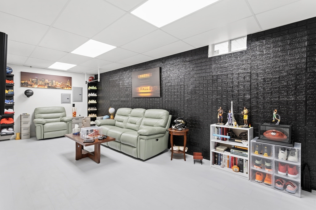 5D Manor Drive, Unit B Hooksett, NH 03106 - Photo 35 of 42 a living room with furniture and a flat screen tv